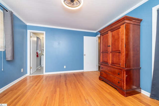 unfurnished bedroom with light wood-type flooring, ensuite bathroom, and crown molding