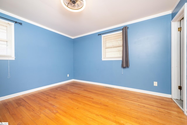 unfurnished room with wood-type flooring and crown molding