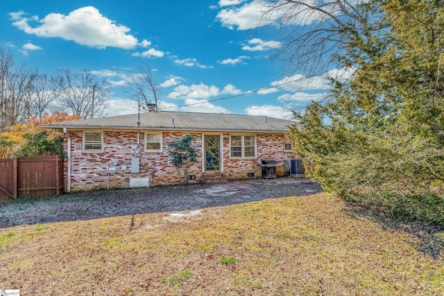 back of house with a yard and central AC