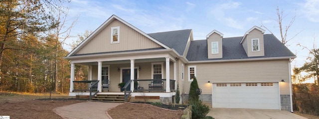 view of front of property featuring a porch and a garage