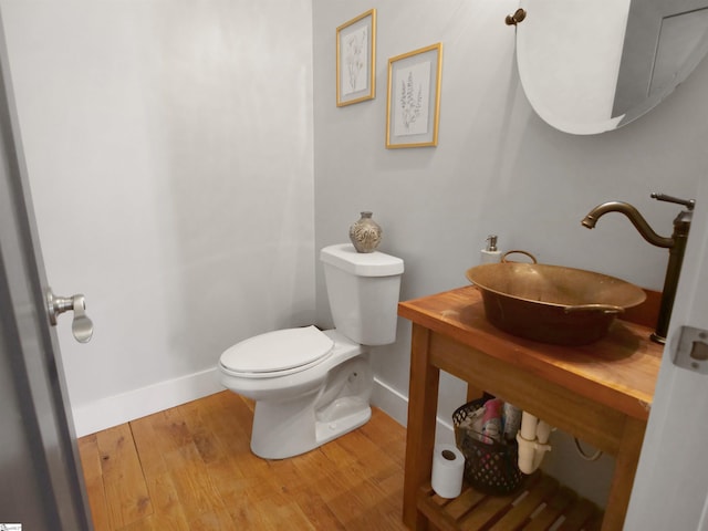 bathroom featuring hardwood / wood-style floors, toilet, and sink