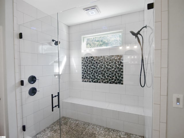 bathroom featuring a shower with shower door