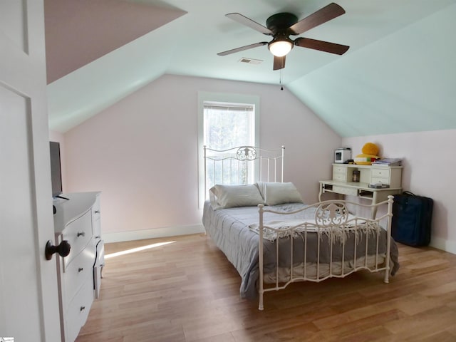 bedroom featuring ceiling fan, light hardwood / wood-style floors, and vaulted ceiling