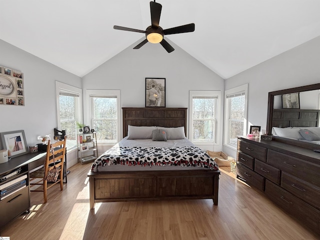 bedroom with ceiling fan, light hardwood / wood-style flooring, and lofted ceiling