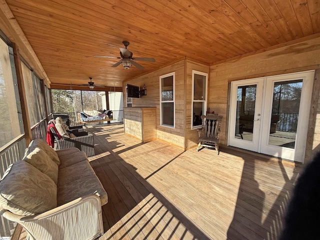 wooden terrace with ceiling fan and french doors