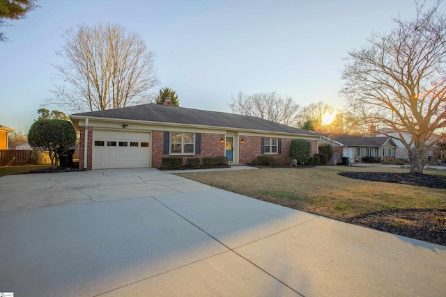 ranch-style house featuring a lawn and a garage