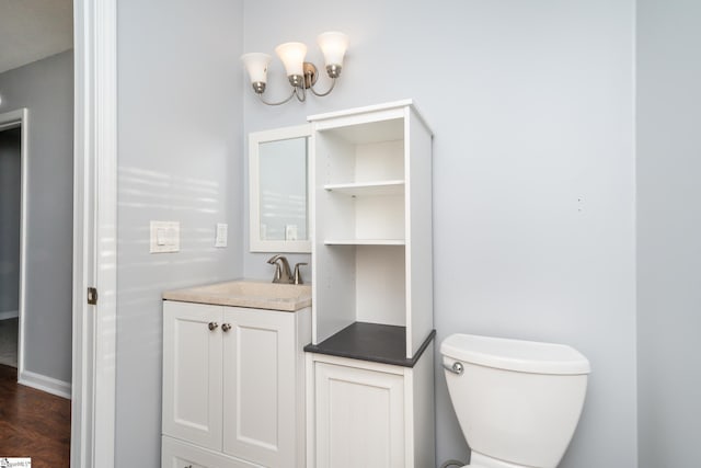 bathroom featuring vanity, hardwood / wood-style flooring, and toilet