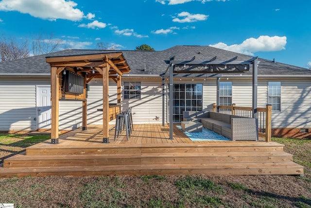 back of property with an outdoor living space, a pergola, and a deck