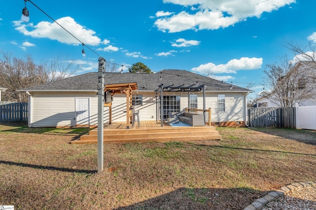 back of house with a pergola, a wooden deck, and a lawn