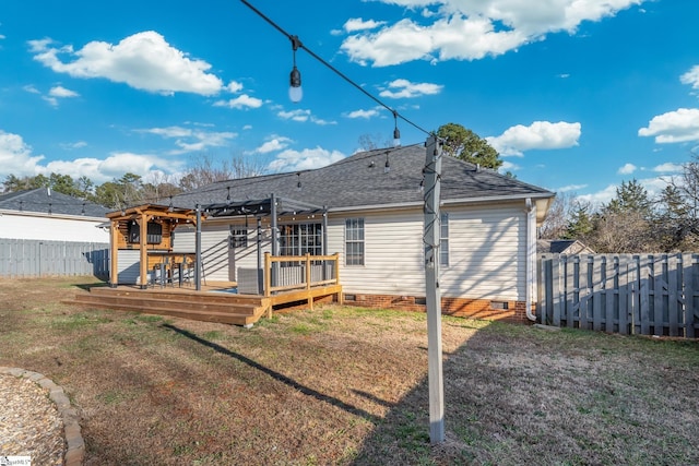 back of property featuring a yard, a pergola, and a wooden deck