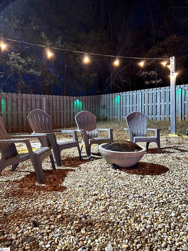 yard at twilight with a fire pit