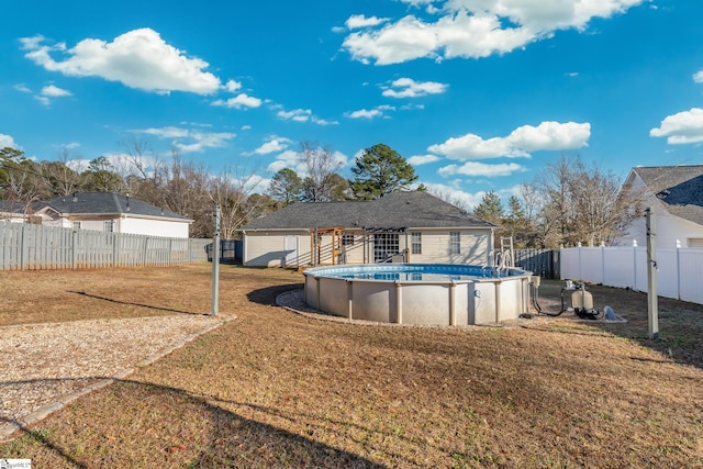 exterior space with a fenced in pool and a lawn