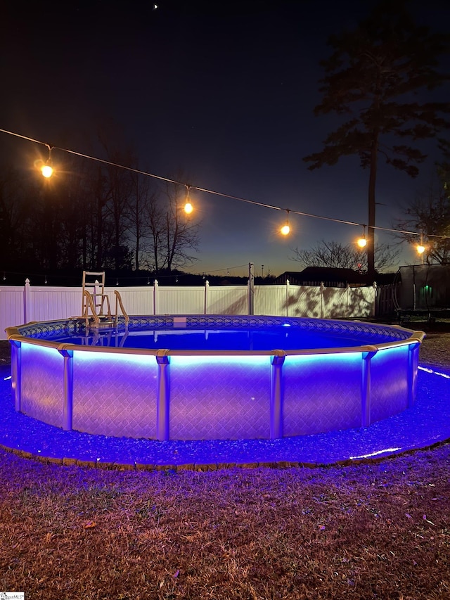 view of pool at night