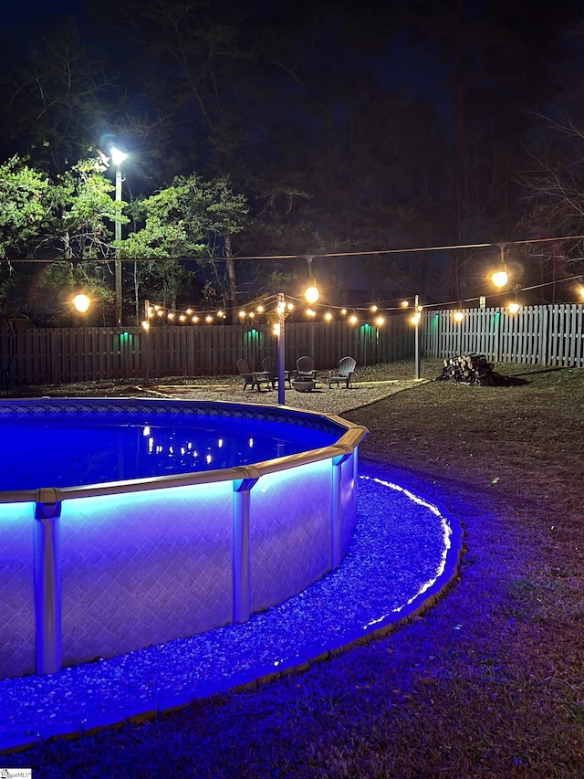 view of pool at night