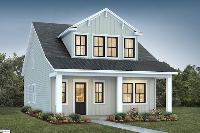 modern inspired farmhouse with covered porch and a front lawn