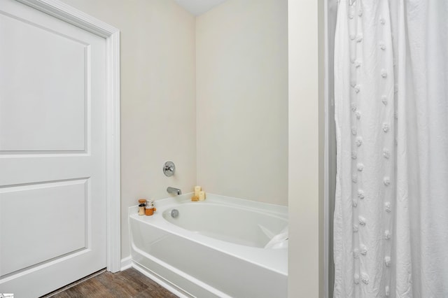 bathroom with a bathtub and wood-type flooring