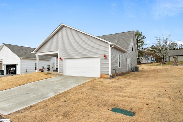 view of front facade featuring central AC, a front lawn, and a garage