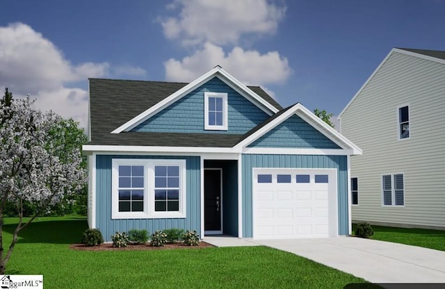 view of front of home featuring a garage and a front yard