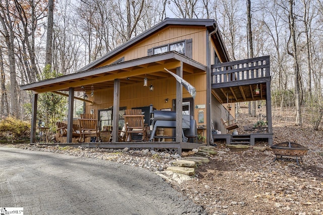 view of front of home featuring a fire pit and a wooden deck