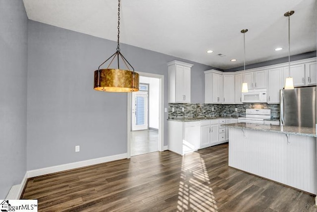 kitchen featuring white appliances, white cabinetry, decorative light fixtures, and light stone countertops