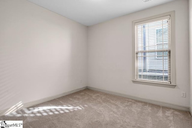 spare room with light carpet