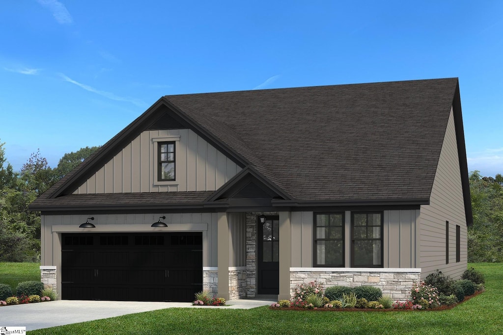 view of front of property with a front lawn and a garage