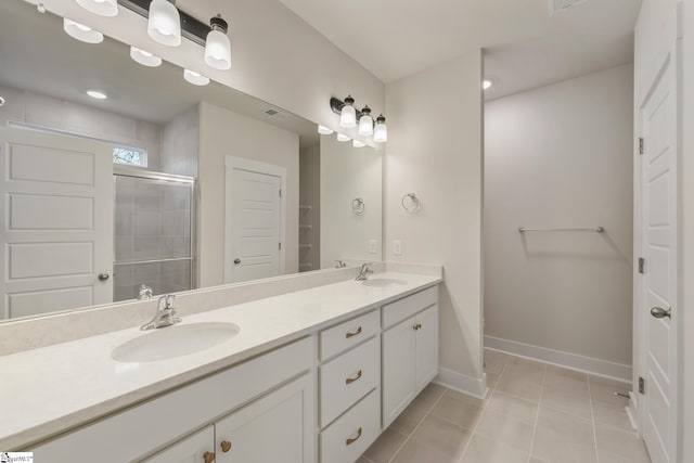 bathroom featuring tile patterned flooring, vanity, and a shower with shower door