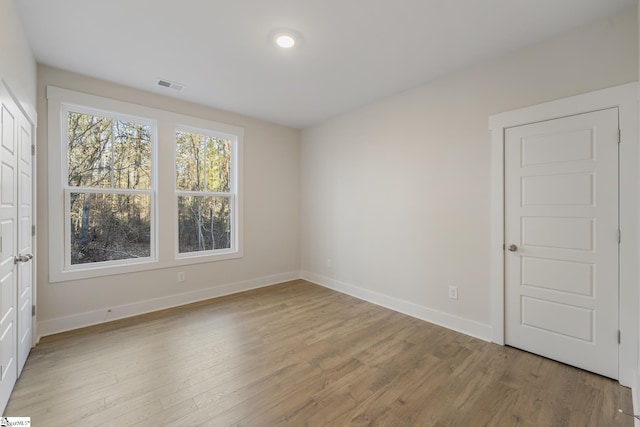 spare room with light hardwood / wood-style floors