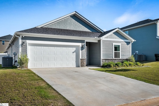 craftsman-style home featuring central AC, a front lawn, and a garage