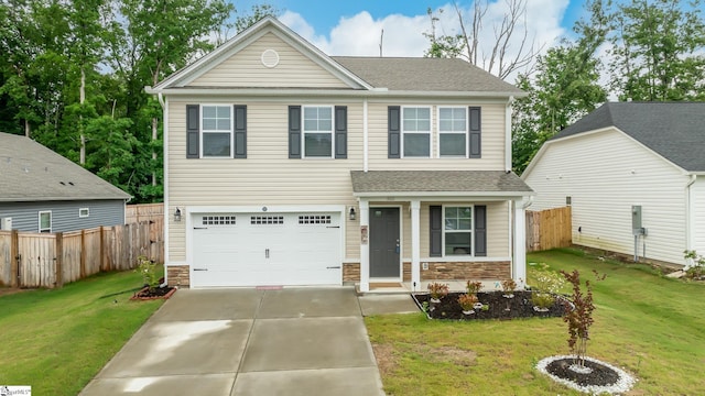 view of front of property with a front yard and a garage