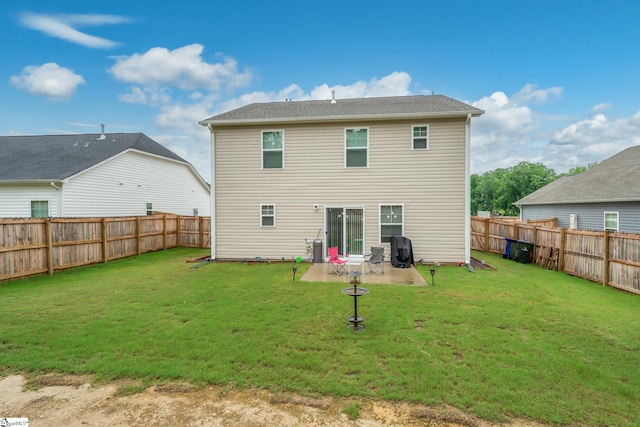 rear view of property featuring a yard and a patio