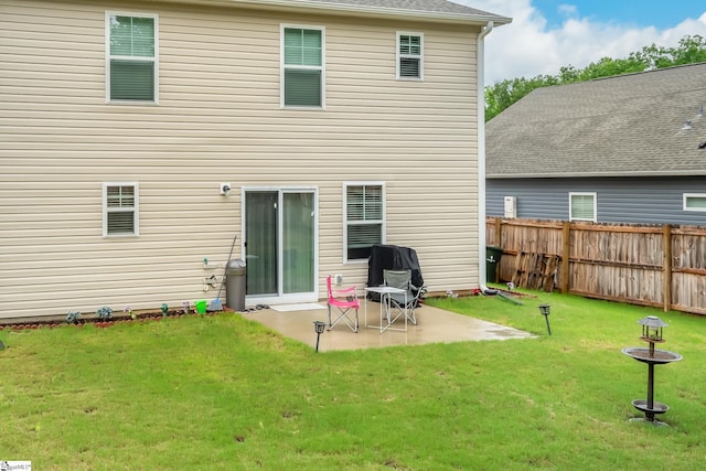 back of property featuring a yard and a patio area