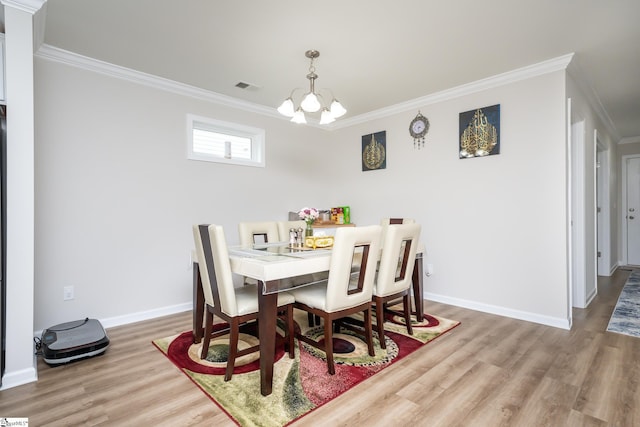 dining space with an inviting chandelier, wood-type flooring, and ornamental molding