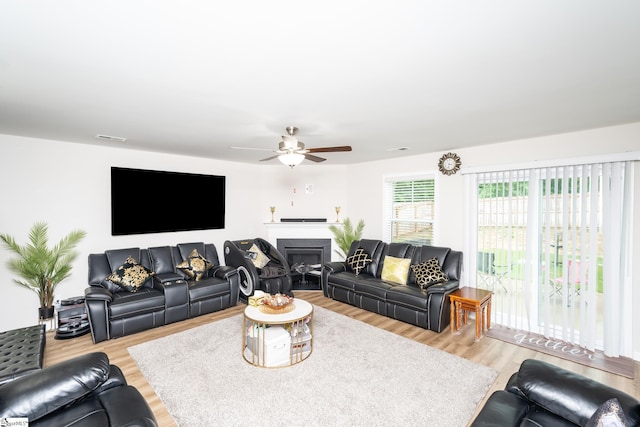 living room featuring ceiling fan and light hardwood / wood-style floors