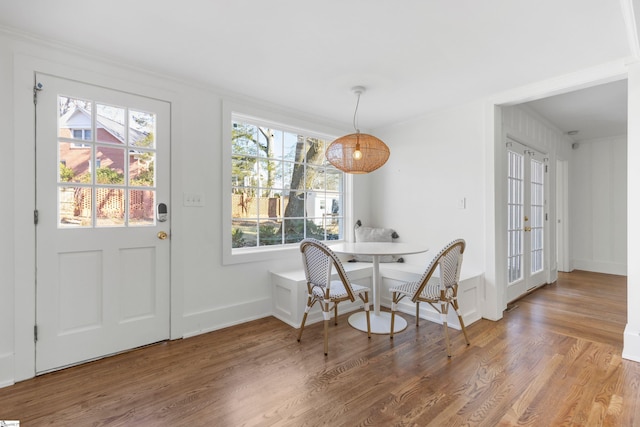 dining area featuring hardwood / wood-style flooring and crown molding