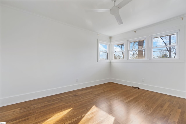 empty room featuring ceiling fan and hardwood / wood-style floors