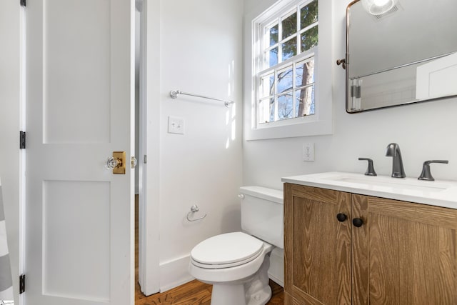 bathroom featuring hardwood / wood-style flooring, vanity, and toilet