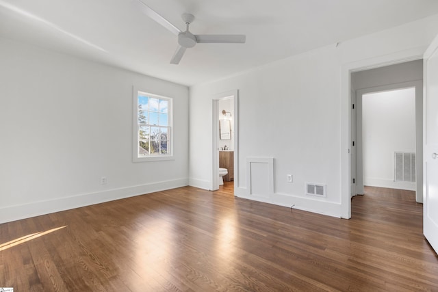 unfurnished bedroom with ensuite bathroom, dark hardwood / wood-style flooring, and ceiling fan