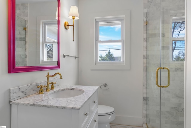 bathroom with vanity, toilet, and an enclosed shower