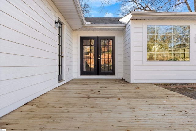 view of exterior entry featuring a deck and french doors