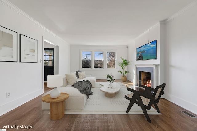 living room featuring dark hardwood / wood-style flooring, plenty of natural light, and crown molding