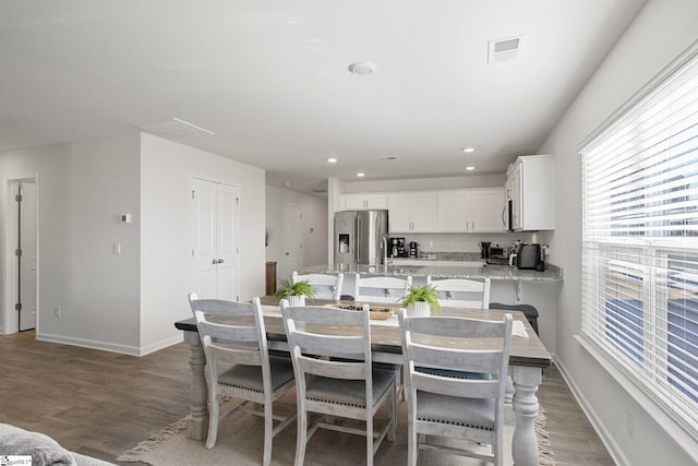 dining room with dark hardwood / wood-style flooring