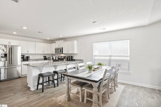 dining area with light wood-type flooring