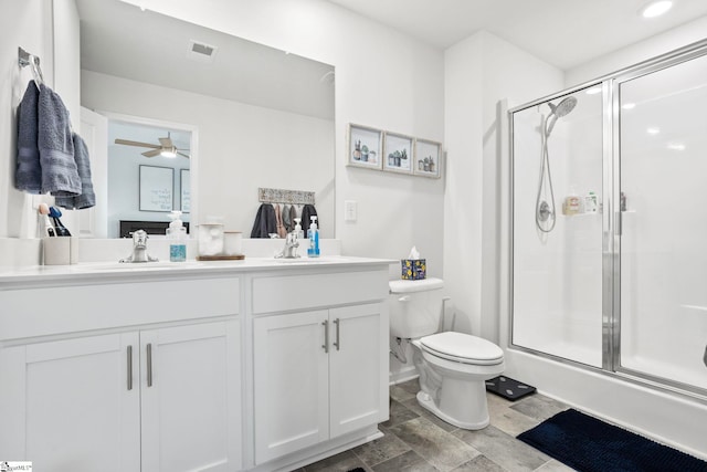 bathroom with vanity, toilet, walk in shower, and ceiling fan