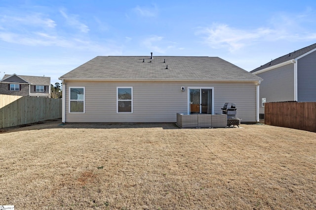 rear view of property featuring a lawn and outdoor lounge area