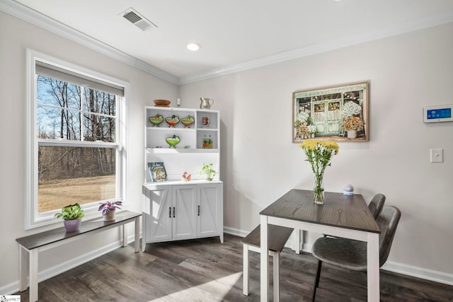 dining room featuring crown molding and dark hardwood / wood-style floors