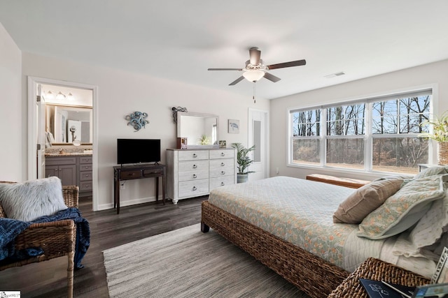 bedroom featuring ensuite bath, ceiling fan, and dark hardwood / wood-style floors