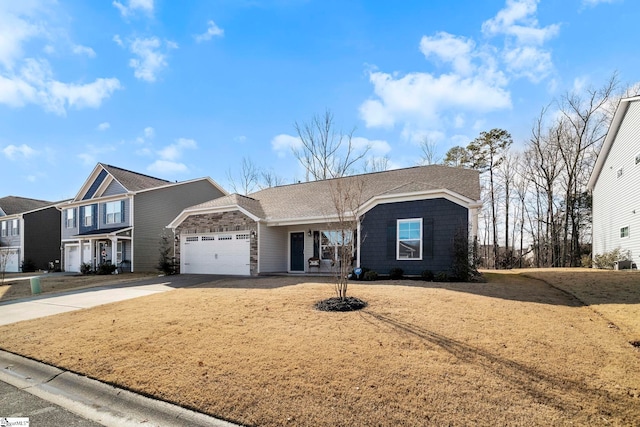 view of front of home with a garage and a front lawn