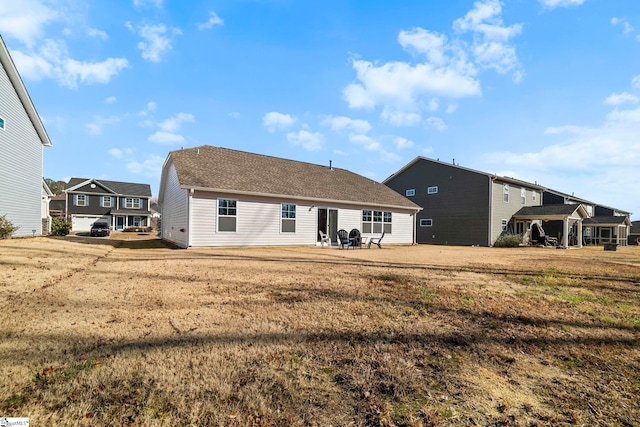 back of house featuring a yard and a patio