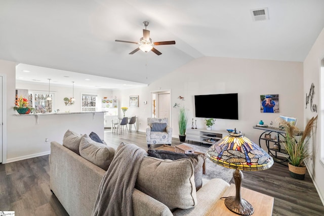 living room with hardwood / wood-style floors, vaulted ceiling, and ceiling fan